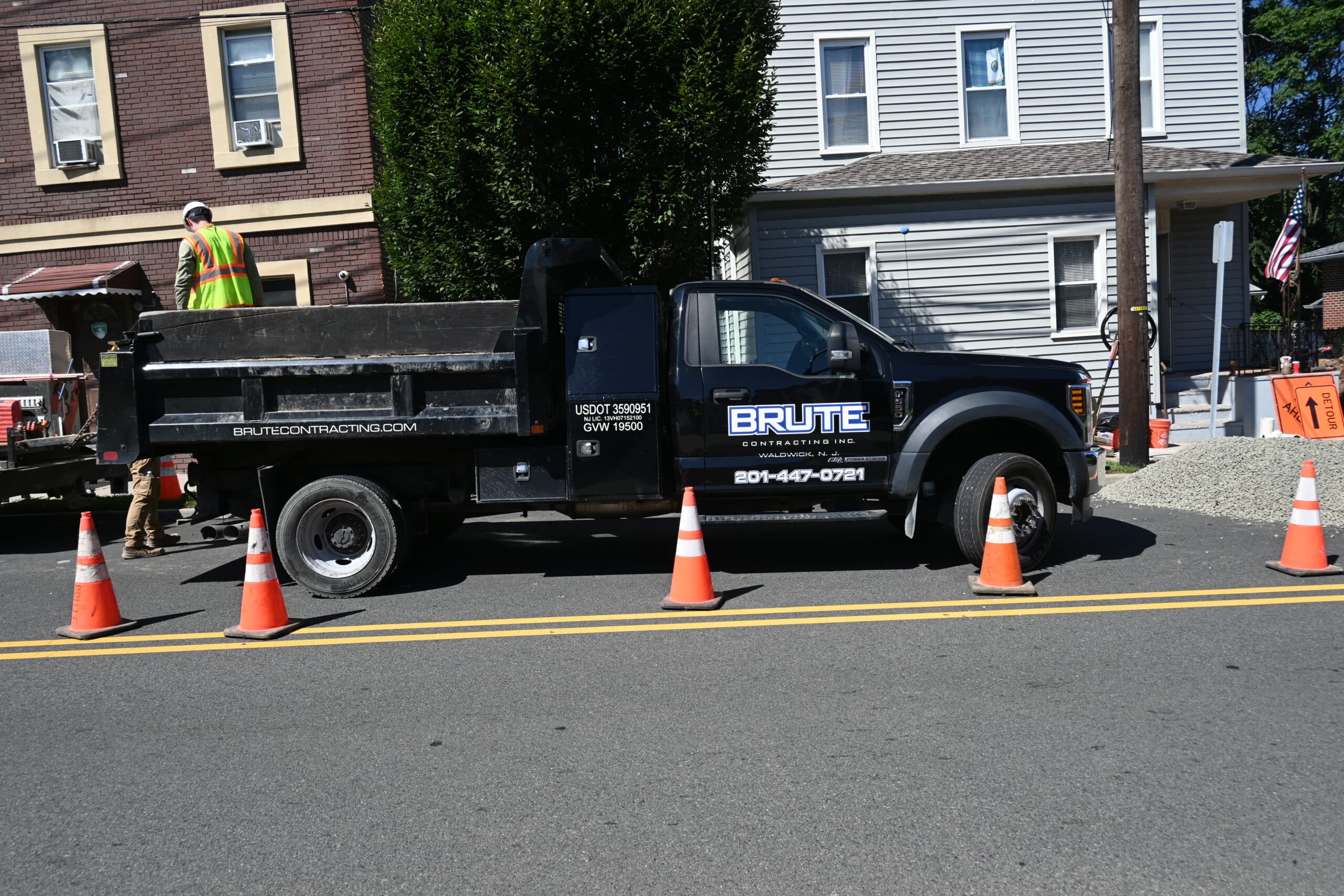 BRUTE Contracting truck in front of residential apartment building and residential home.